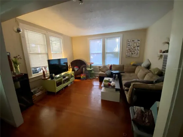 a living room with furniture window and a flat screen tv