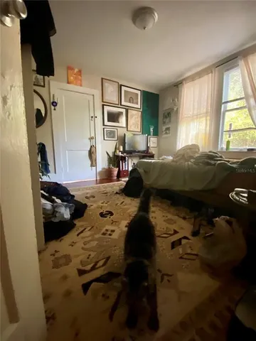 a bedroom with bed and a window