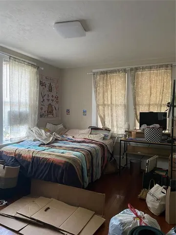 a bedroom with bed couch and window
