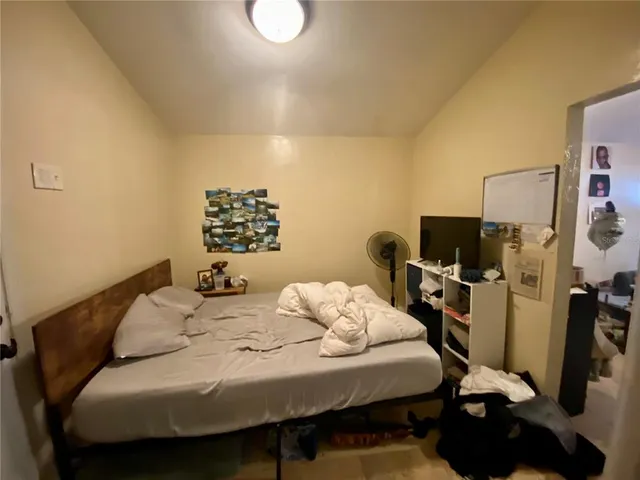 a bedroom with a bed and a flat screen tv