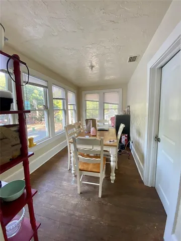 a living room with furniture a large window and a wooden floor