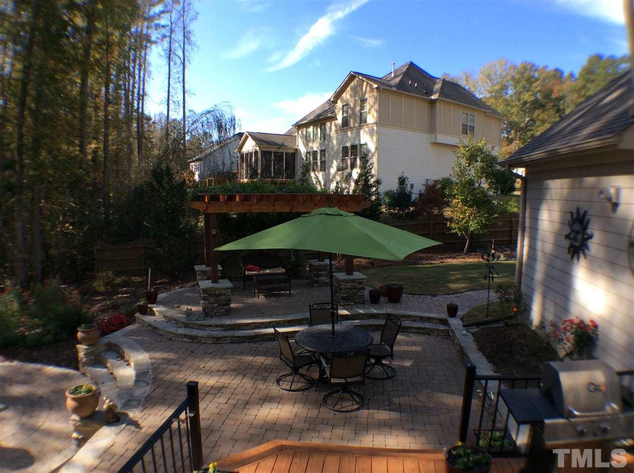 12811 Edsel Drive Raleigh, NC 27613 - Photo 22 of 25 a view of a patio with table and chairs under an umbrella