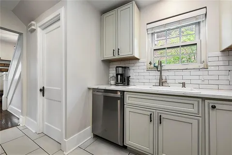 a kitchen with stainless steel appliances white cabinets and a sink