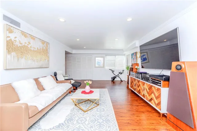 a bedroom with furniture and a wooden floor