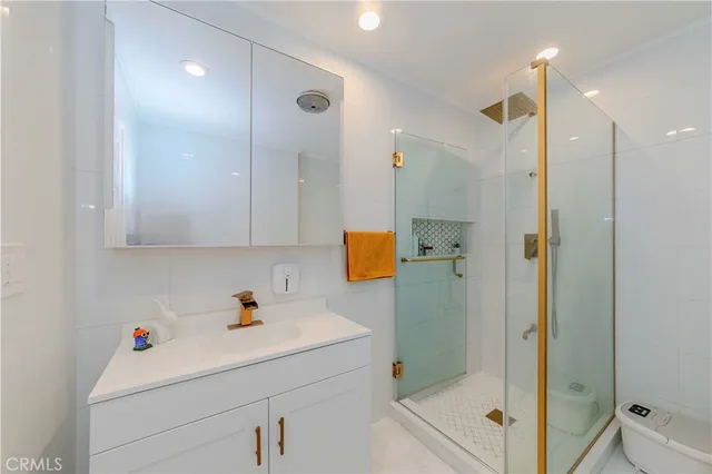 a bathroom with a shower sink and mirror