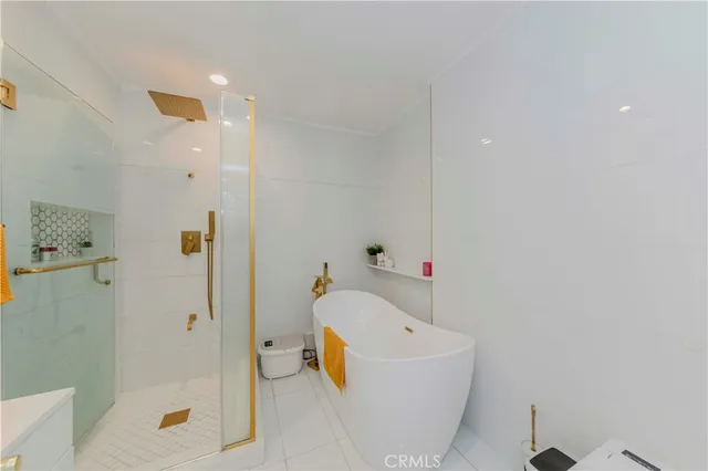 a bathroom with a tub shower and toilet