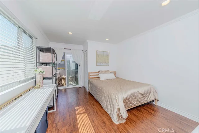 a bedroom with a bed and a large window