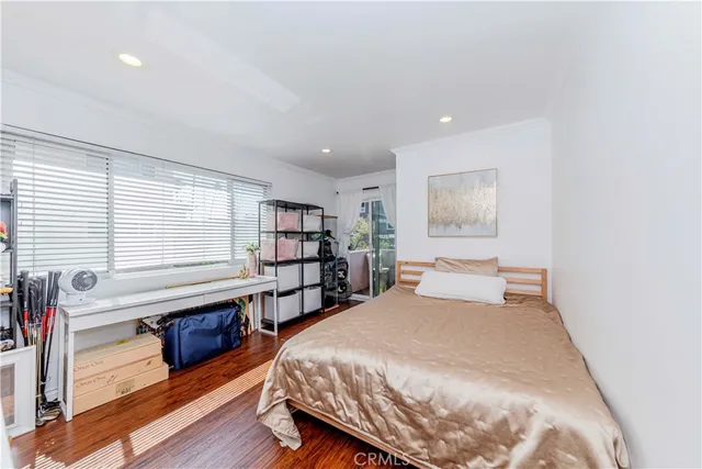 a spacious bedroom with a bed and a large window