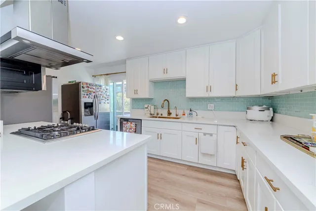 a kitchen with stainless steel appliances granite countertop a sink stove and cabinets