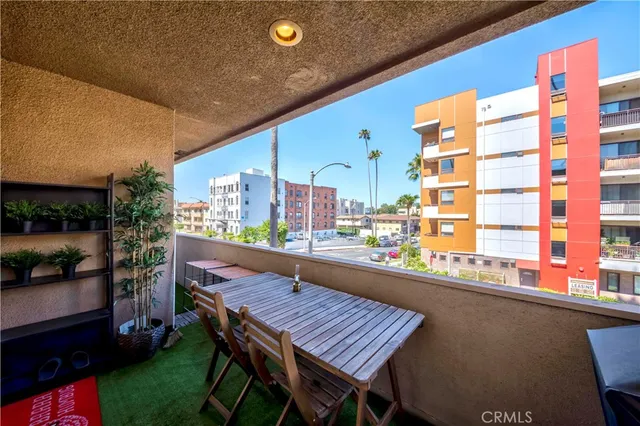 a balcony with wooden floor and outdoor seating