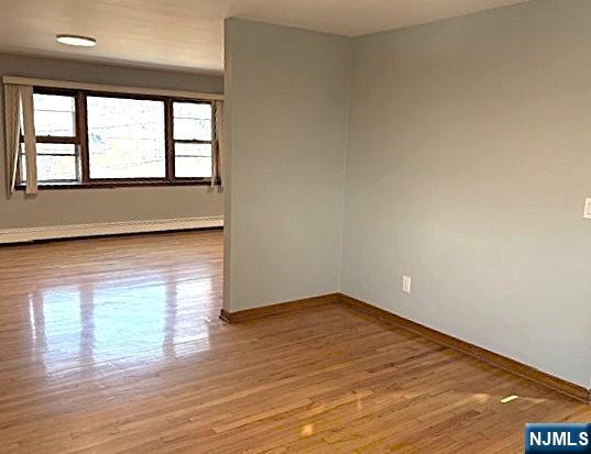 650 Edgewater Avenue, Unit 2 Ridgefield, NJ 07657 - Photo 3 of 8 wooden floor in an empty room with a window
