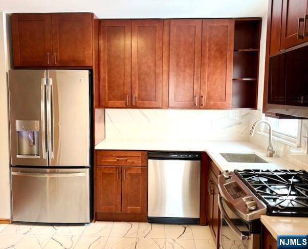 650 Edgewater Avenue, Unit 2 Ridgefield, NJ 07657 - Photo 5 of 8 a kitchen with a refrigerator and a sink