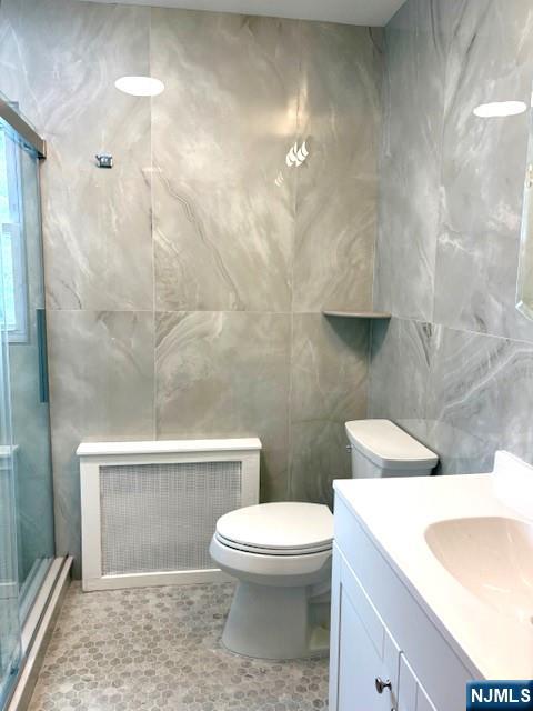 650 Edgewater Avenue, Unit 2 Ridgefield, NJ 07657 - Photo 6 of 8 a bathroom with a sink a toilet and shower