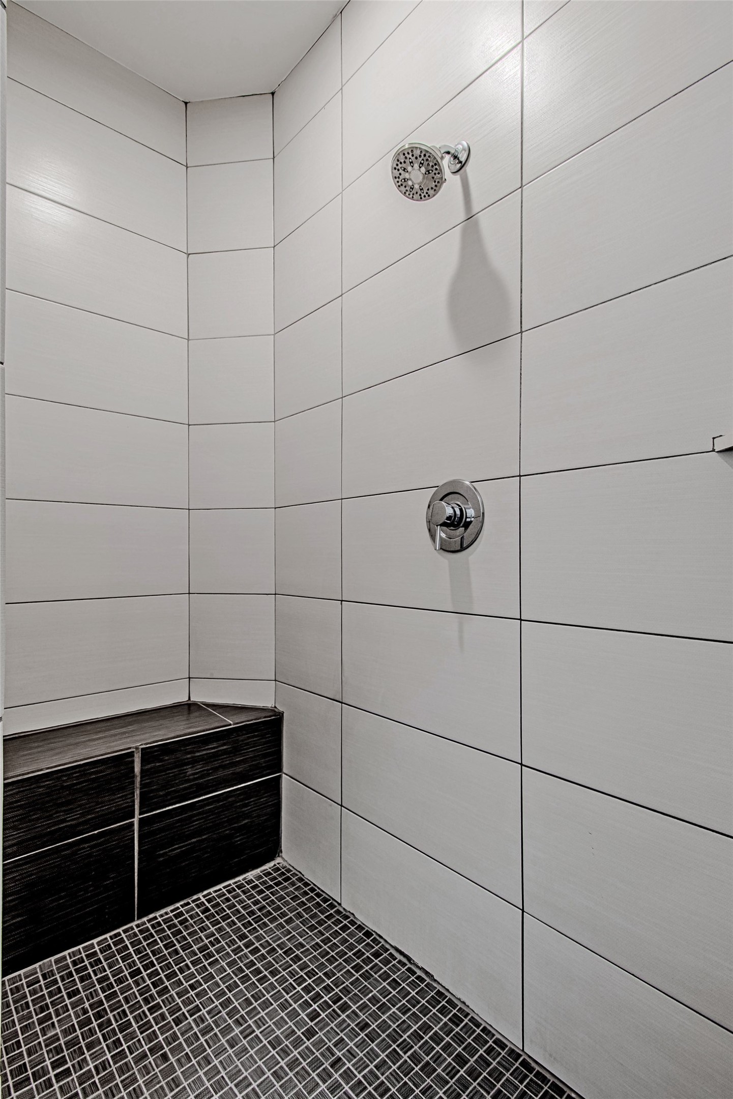 2025 Colquitt Street, Unit E Houston, TX 77098 - Photo 21 of 29 Walk-in shower with sleek tile finishes and built-in bench.