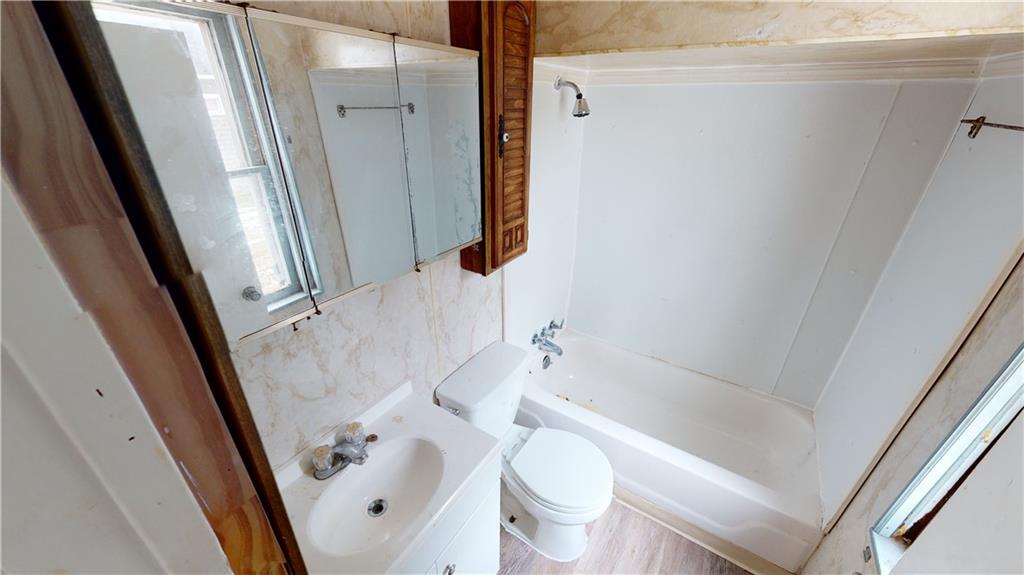 1112 Webster Street Farrell, PA 16121 - Photo 13 of 20 a bathroom with a sink a toilet a tub and shower
