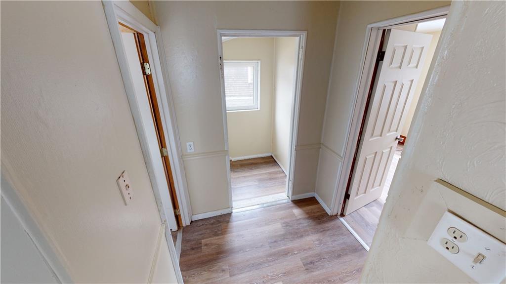 1112 Webster Street Farrell, PA 16121 - Photo 14 of 20 a view of a hallway with wooden floor and stairs