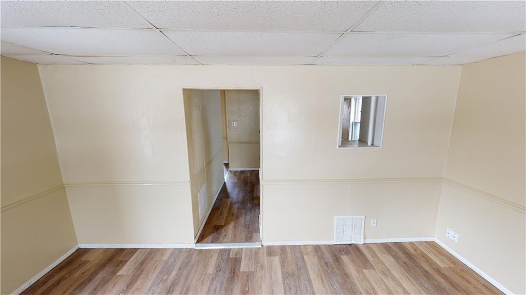 1112 Webster Street Farrell, PA 16121 - Photo 3 of 20 a view of a room with wooden floor and a window