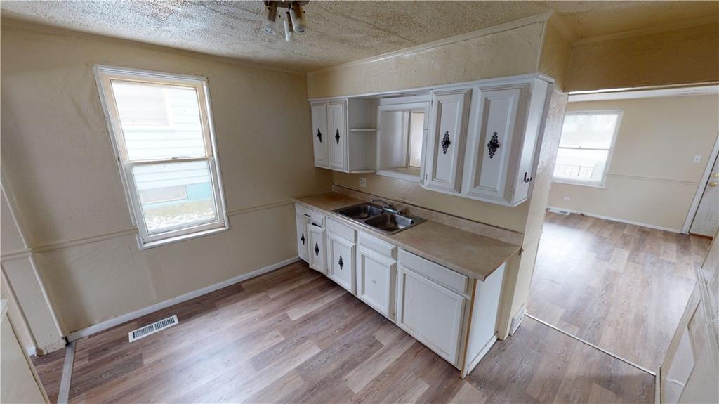 1112 Webster Street Farrell, PA 16121 - Photo 6 of 20 a kitchen with stainless steel appliances granite countertop a stove a sink and a refrigerator