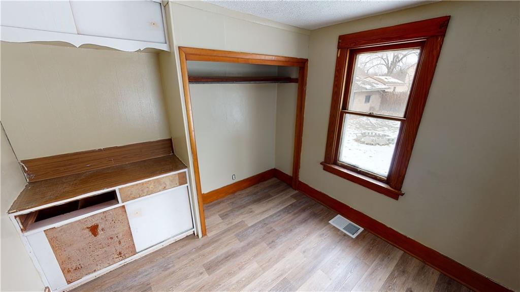 1112 Webster Street Farrell, PA 16121 - Photo 9 of 20 a view of an empty room with wooden floor and a window
