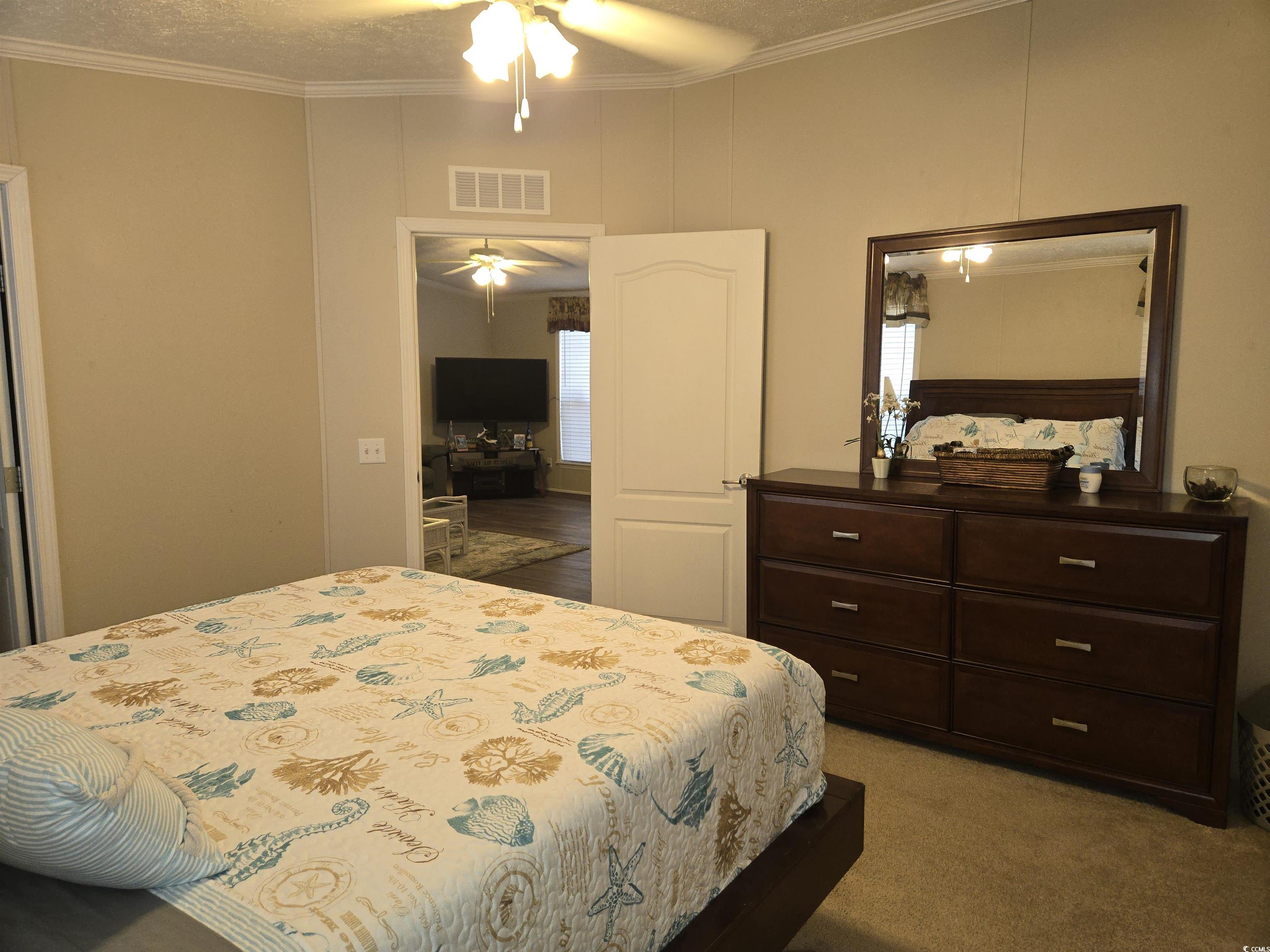 361 East Canal Street Murrells Inlet, SC 29576 - Photo 15 of 35 Bedroom featuring light carpet, visible vents, and crown molding