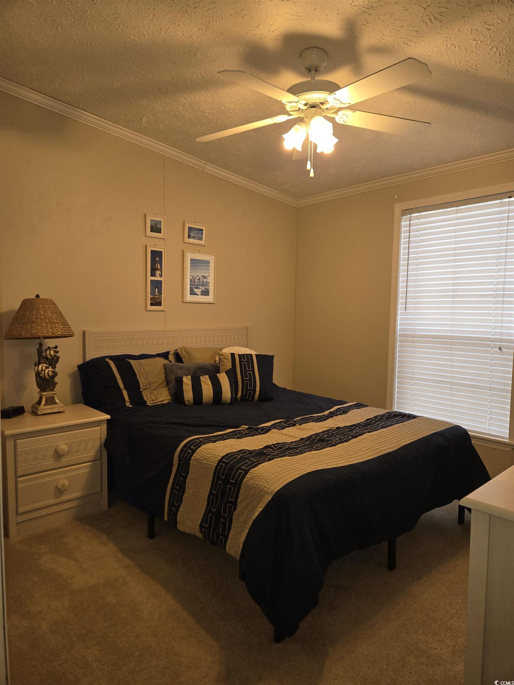 361 East Canal Street Murrells Inlet, SC 29576 - Photo 16 of 35 Carpeted bedroom with a textured ceiling, crown molding, and ceiling fan