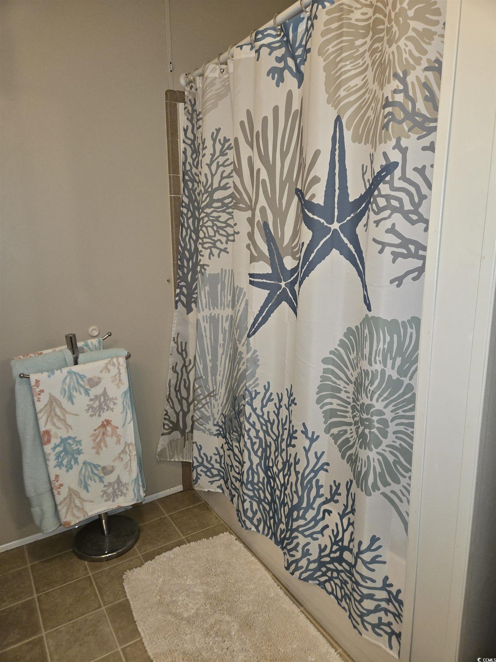 361 East Canal Street Murrells Inlet, SC 29576 - Photo 20 of 35 Full bathroom with a shower with shower curtain and tile patterned flooring