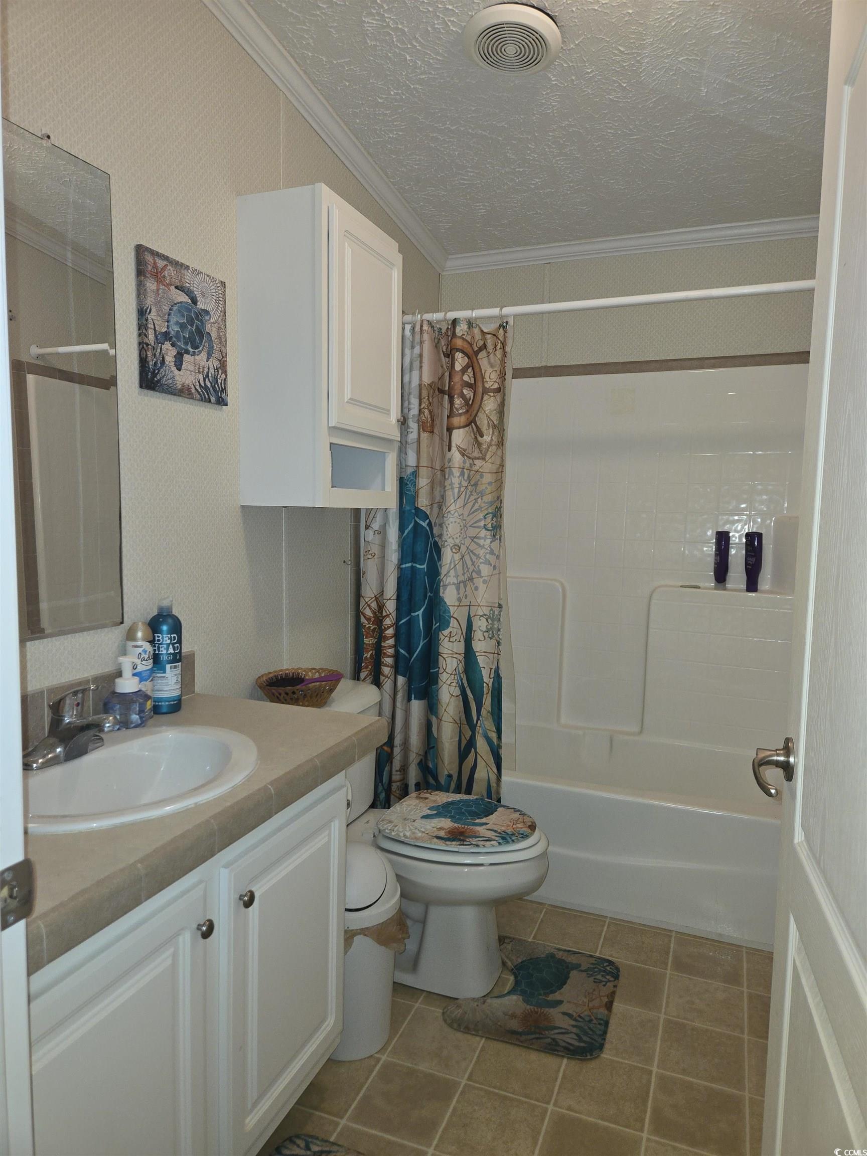 361 East Canal Street Murrells Inlet, SC 29576 - Photo 25 of 35 Full bathroom with visible vents, toilet, ornamental molding, a textured ceiling, and vanity