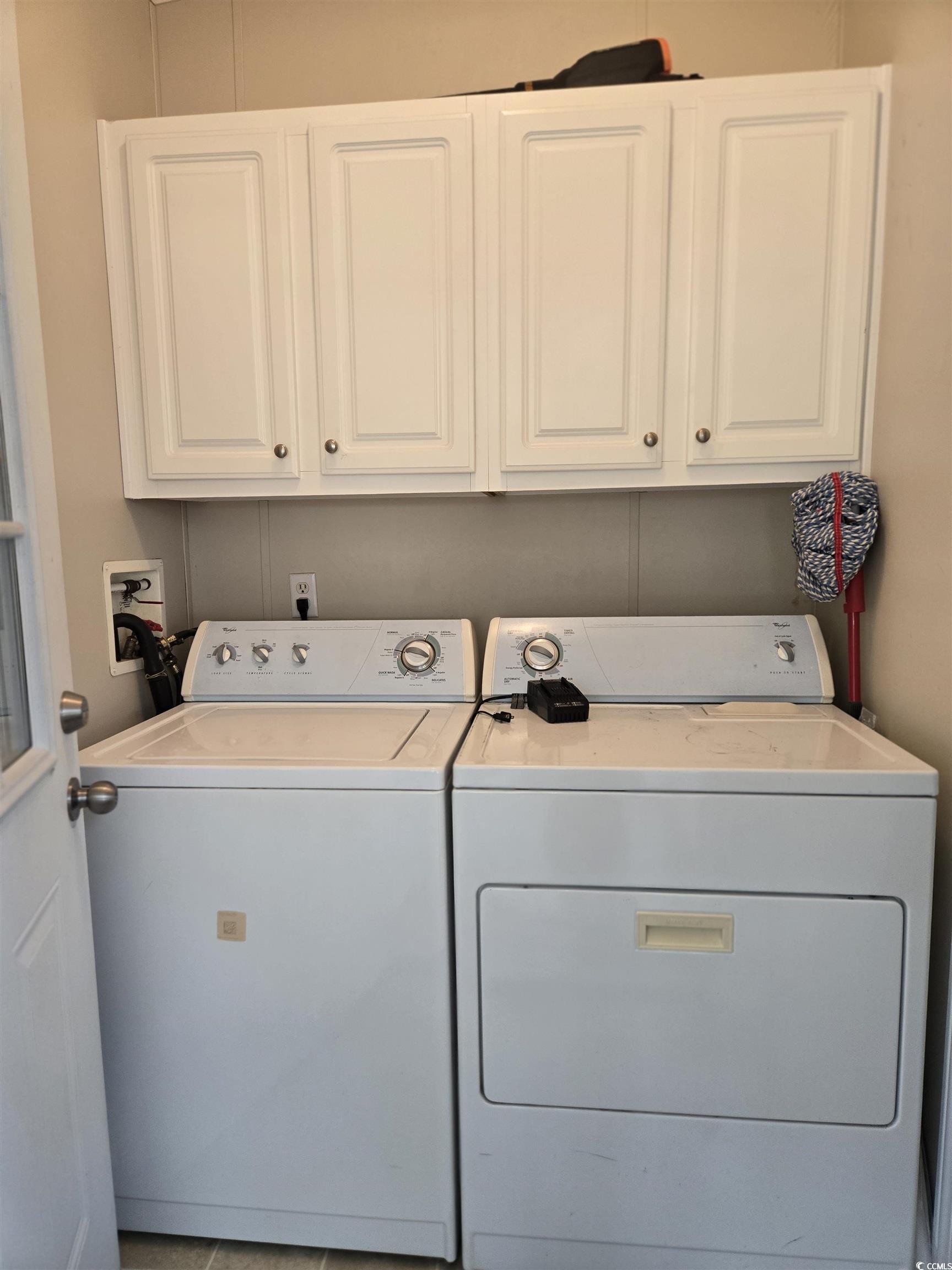 361 East Canal Street Murrells Inlet, SC 29576 - Photo 26 of 35 Clothes washing area featuring washer and dryer and cabinet space