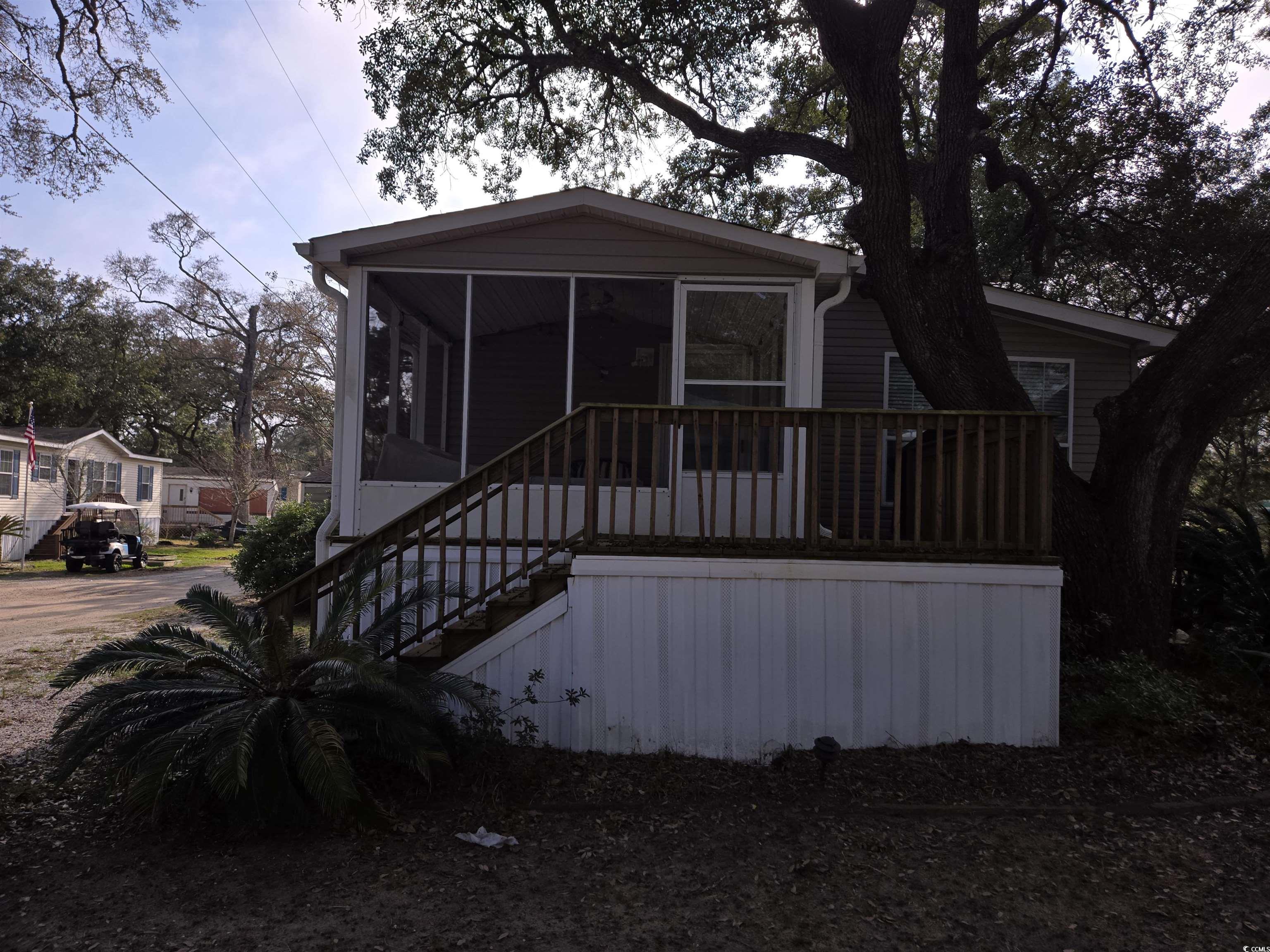 361 East Canal Street Murrells Inlet, SC 29576 - Photo 4 of 35 View of front of house featuring stairway and a sunroom