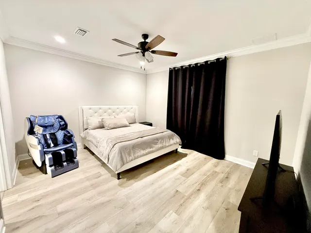 a bedroom with a bed and a large mirror