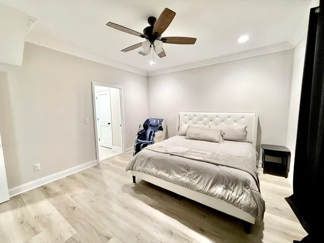 a bedroom with a bed and a ceiling fan