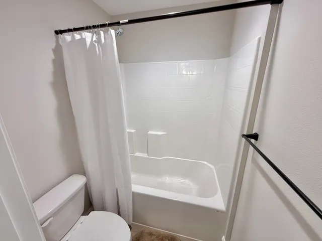 a living room with a couch and a night stand