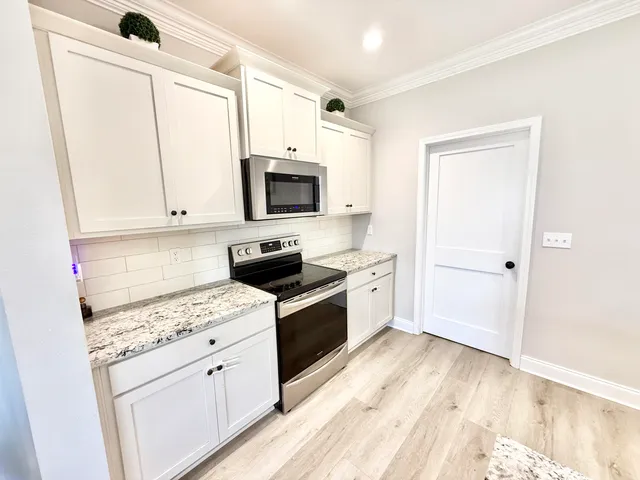 a kitchen with a refrigerator stove and microwave