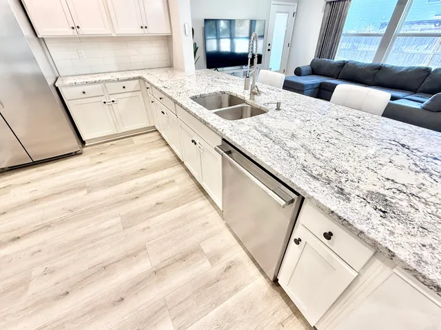a kitchen with a sink and a refrigerator