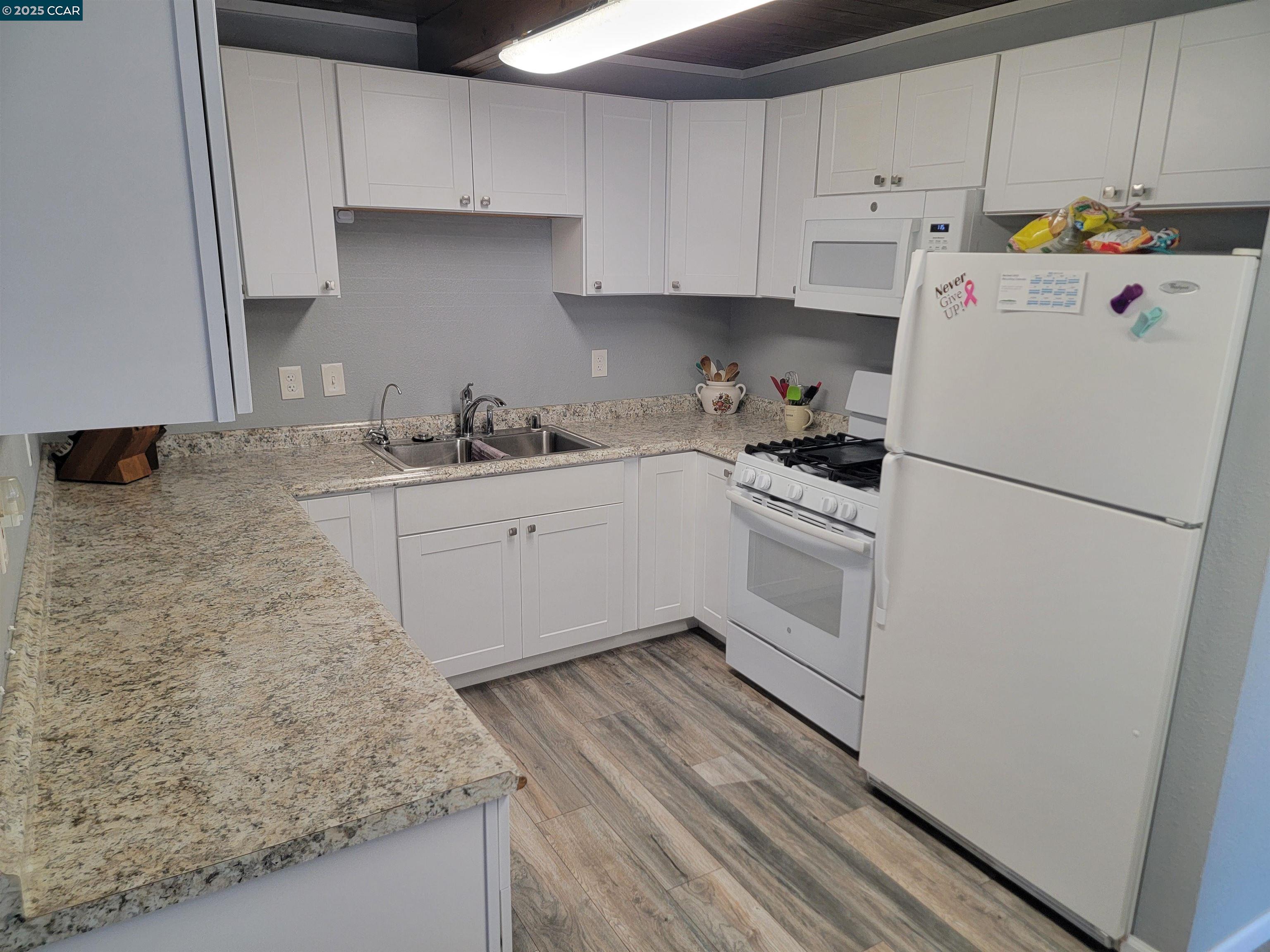 a kitchen with a sink a stove and refrigerator