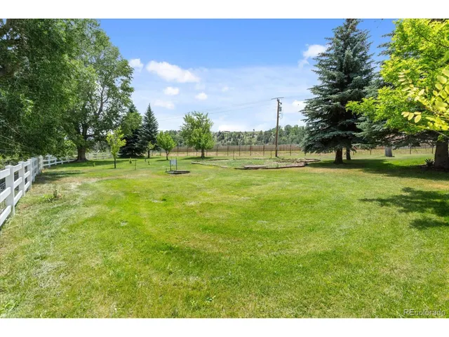 a view of field with trees in the background