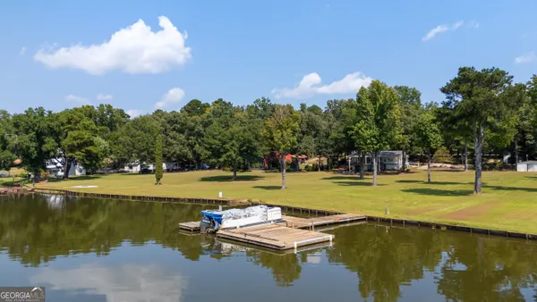 a view of a lake with lawn chairs