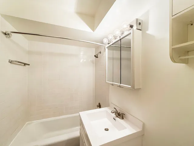 a bathroom with a shower and a sink