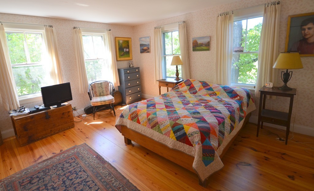 712 Pratt Corner Road Shutesbury, MA 01002 - Photo 11 of 30 a bedroom with bed chair and window