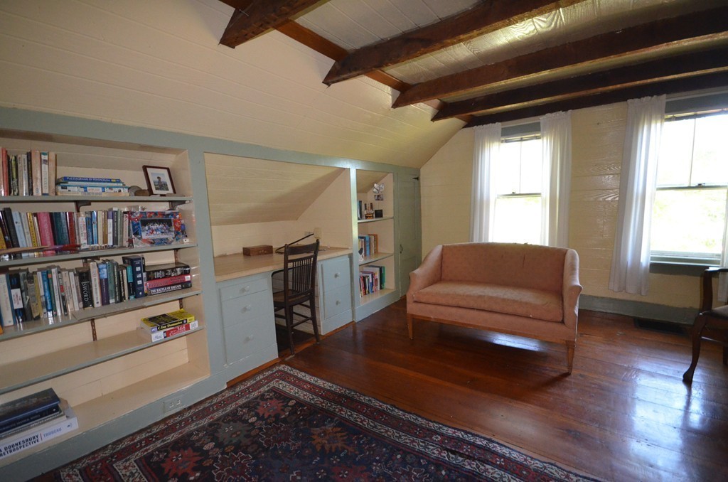 712 Pratt Corner Road Shutesbury, MA 01002 - Photo 17 of 30 a living room with furniture and a book shelf
