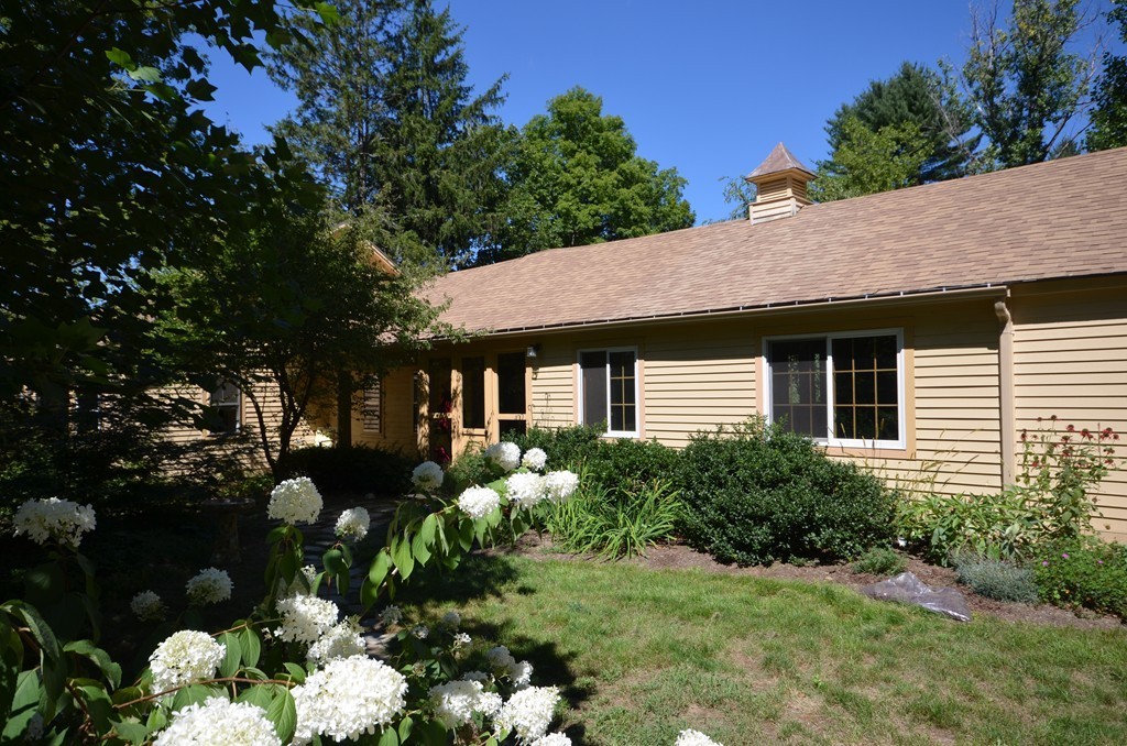 712 Pratt Corner Road Shutesbury, MA 01002 - Photo 28 of 30 a front view of a house with a yard and tree