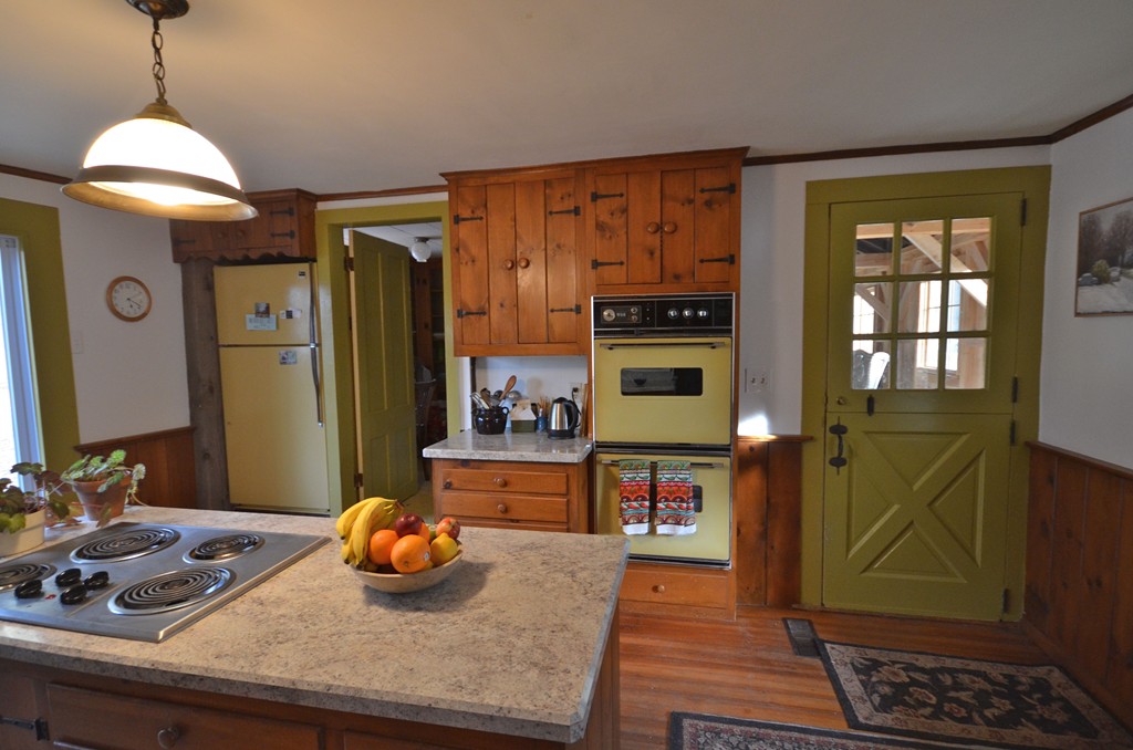 712 Pratt Corner Road Shutesbury, MA 01002 - Photo 7 of 30 a kitchen with stainless steel appliances granite countertop a sink and a wooden floor