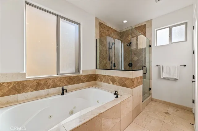 a bathroom with a bathtub and a shower
