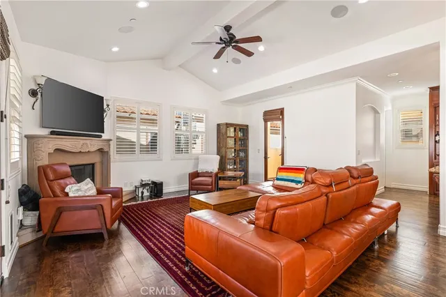 a living room with fireplace furniture and a flat screen tv