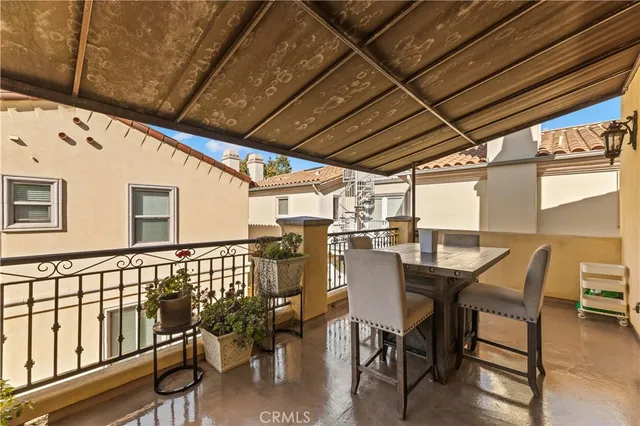 a view of a patio with table and chairs and wooden floor