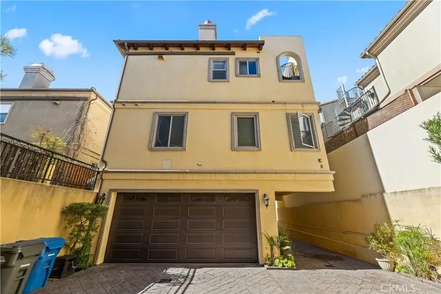 a view of a blue house with large windows