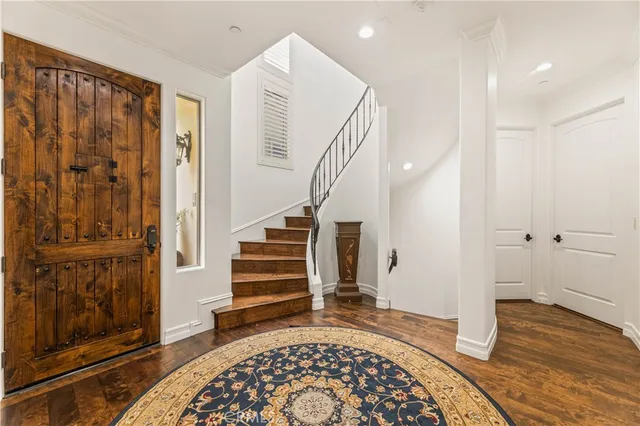 a view of entryway with wooden floor and stairs