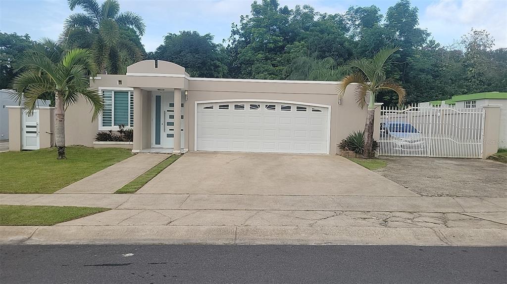 a front view of a house with yard and garage
