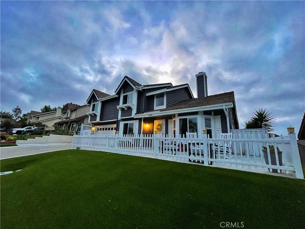 a front view of house with yard and green space