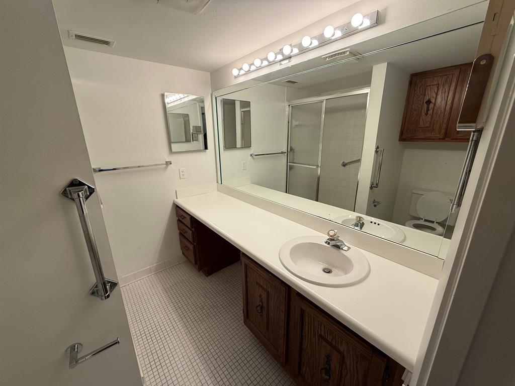 6215 Coral Lake Drive, Unit 203 Margate, FL 33063 - Photo 17 of 46 a bathroom with a double vanity sink a mirror and a shower